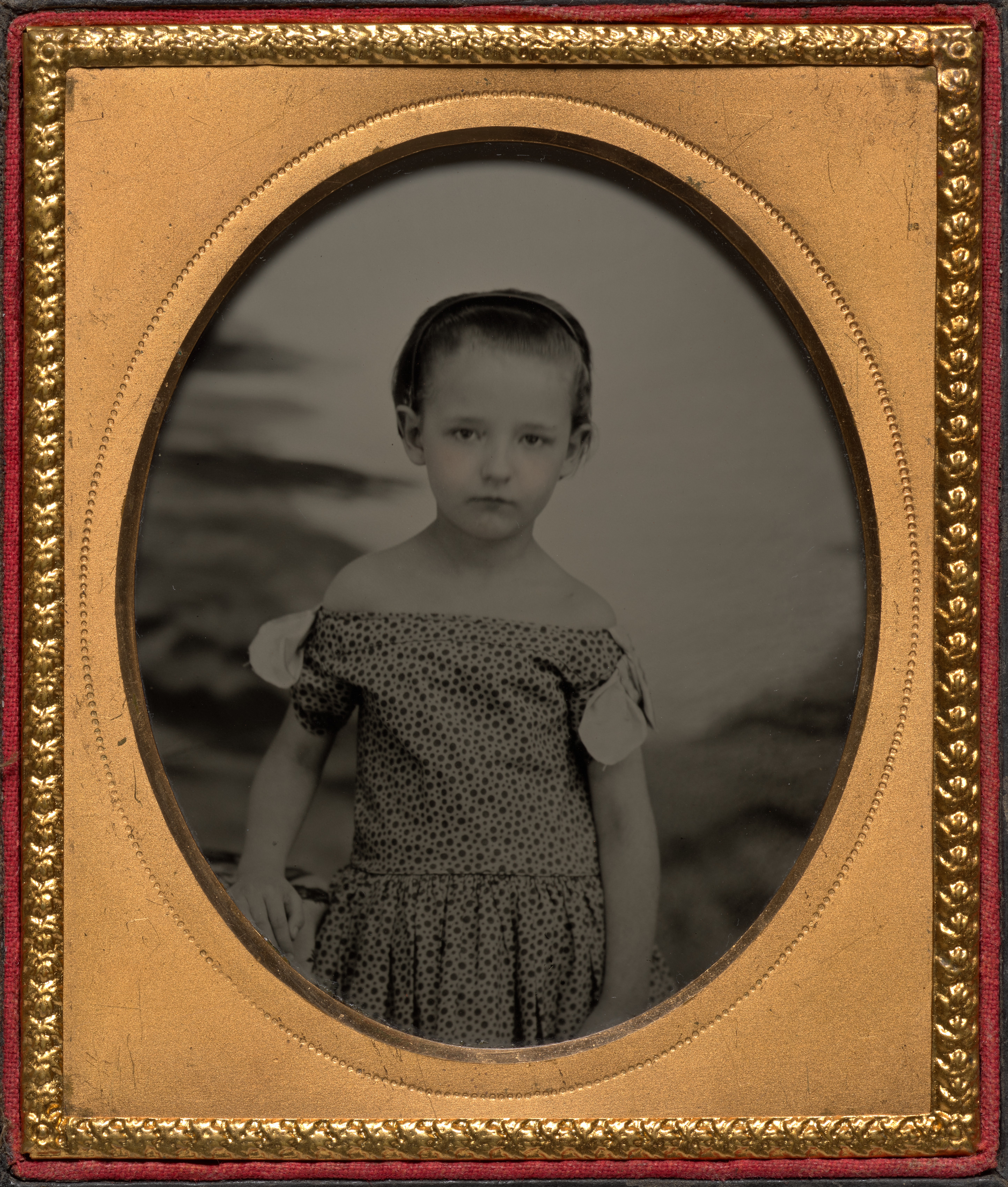 Child in off-shoulder polka dot dress