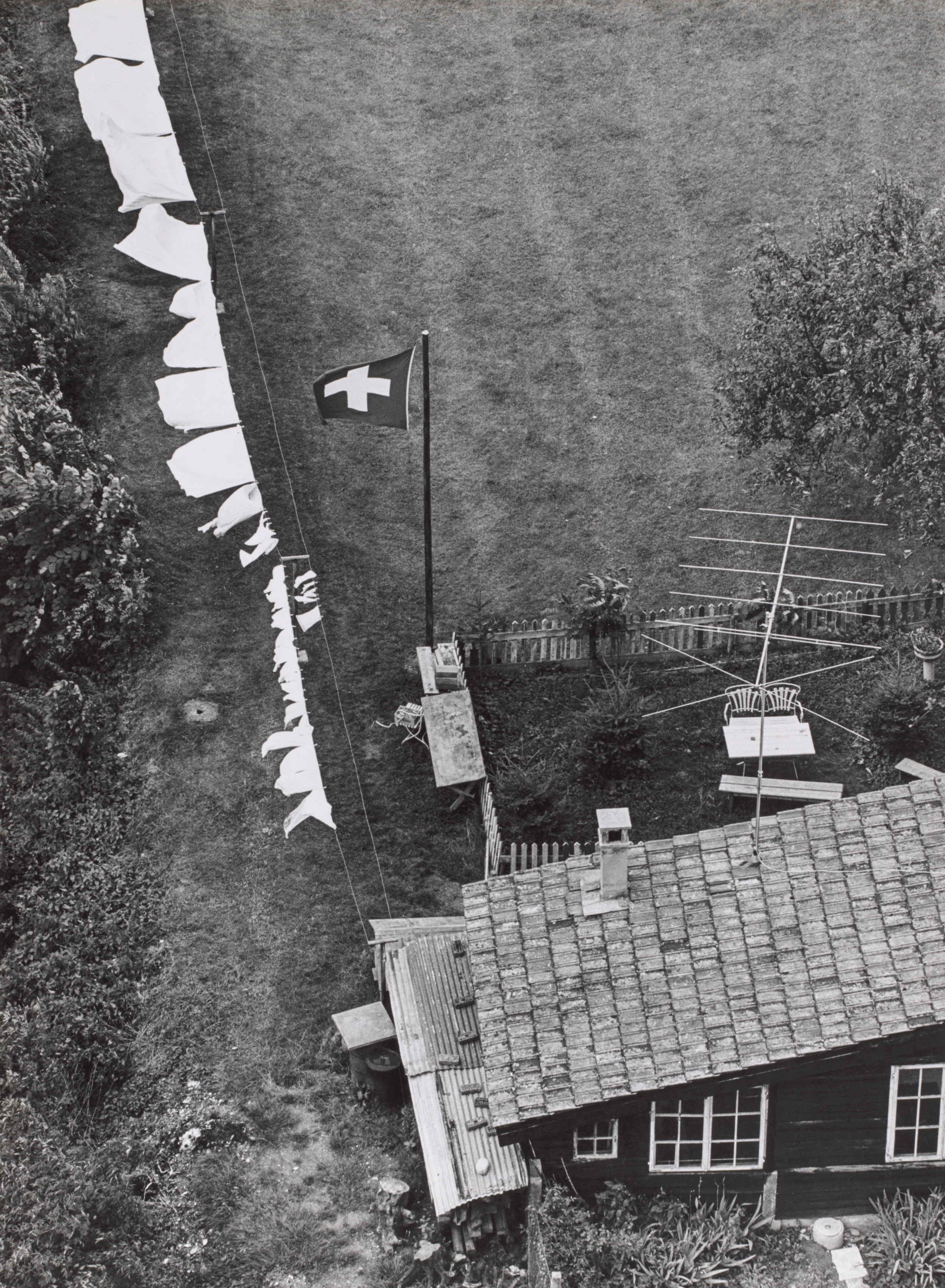 Swiss Happiness: Elevated View of Yard with Drying Laundry and Flag, Switzerland