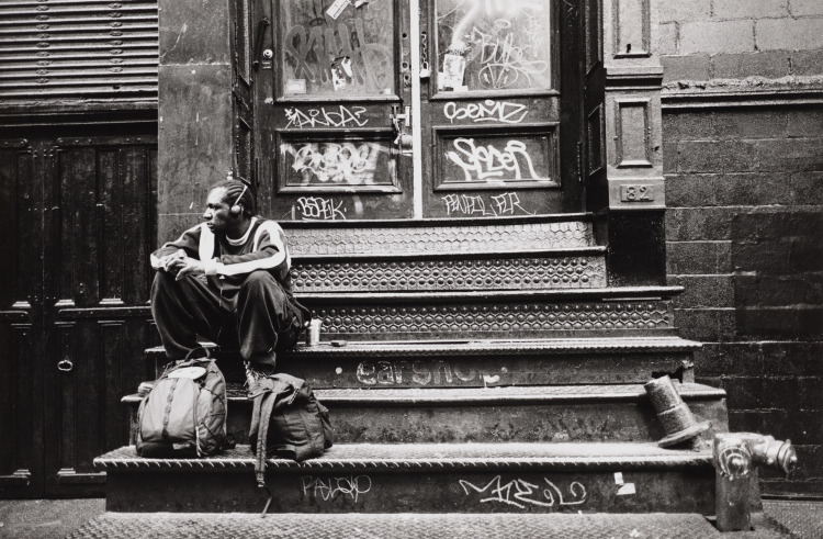 Man Sitting with Backpack on Graffiitied Stoop, Soho, New York City