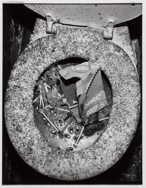 "Shooting Gallery" Lavatory Clogged with Gelatine Capsules and Syringes