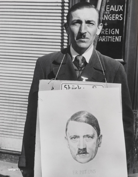 An Austrian Sporting a Hitler Moustache Sold Portraits of the Führer withe the Inscription, "He's With Us, We're With Him," Vienna