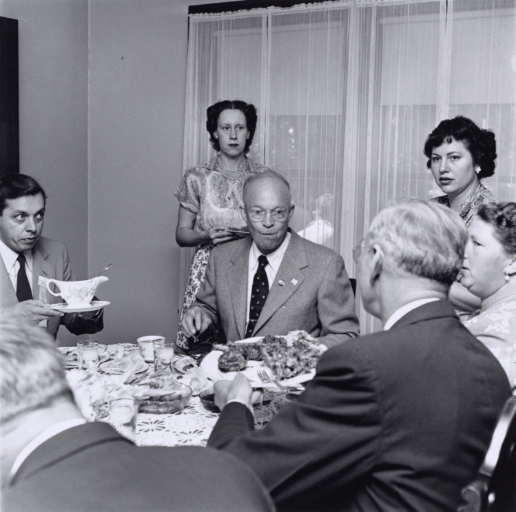 President Eisenhower sitting at a dinner table