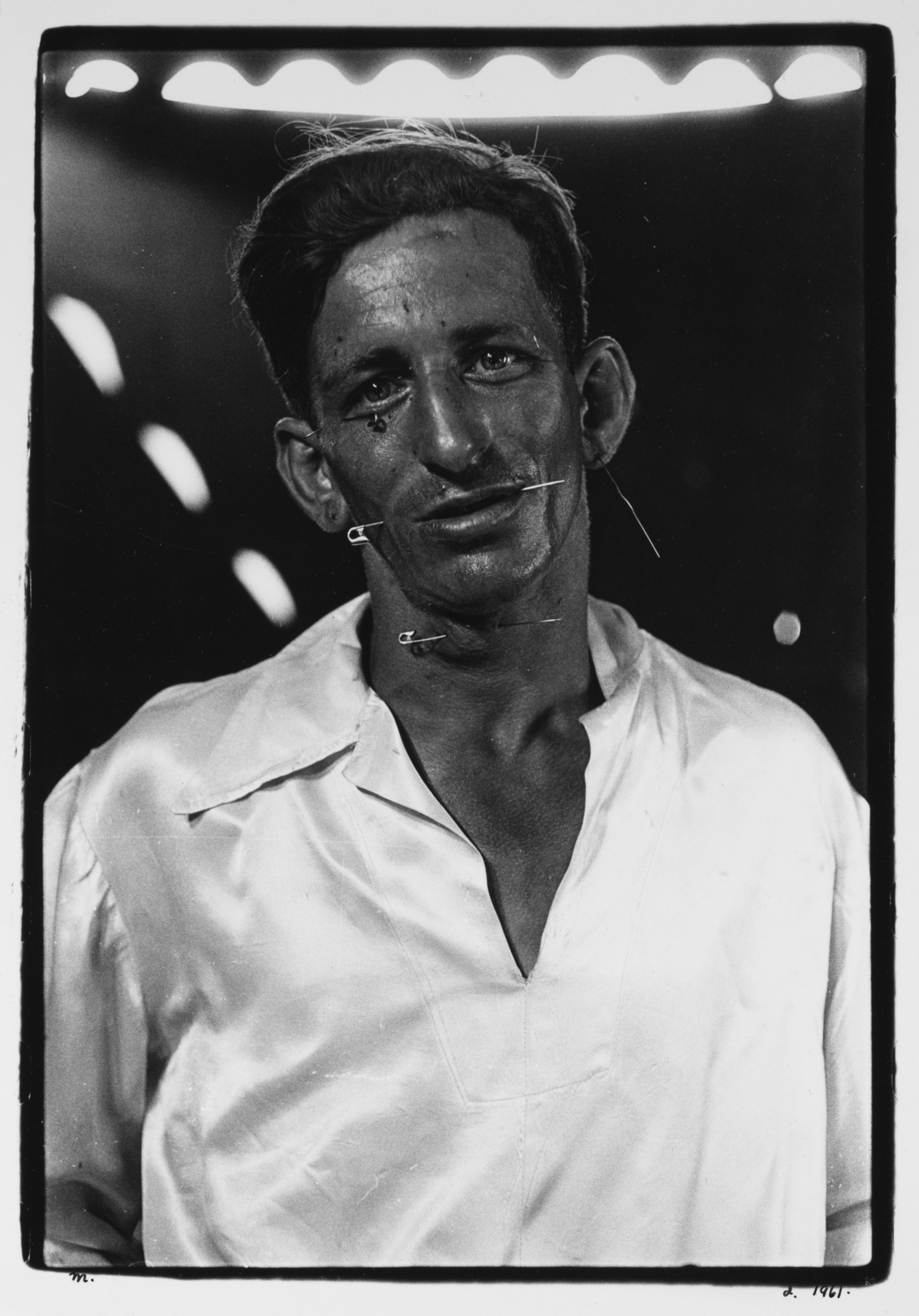 The human pincushion at a carnival in his silk shirt, N.J., 1961