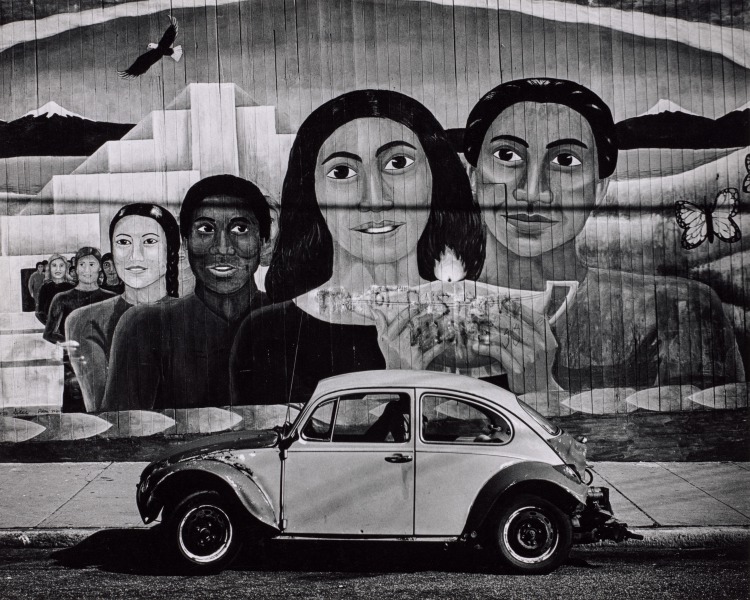 Car Parked in Front of Mural of Women