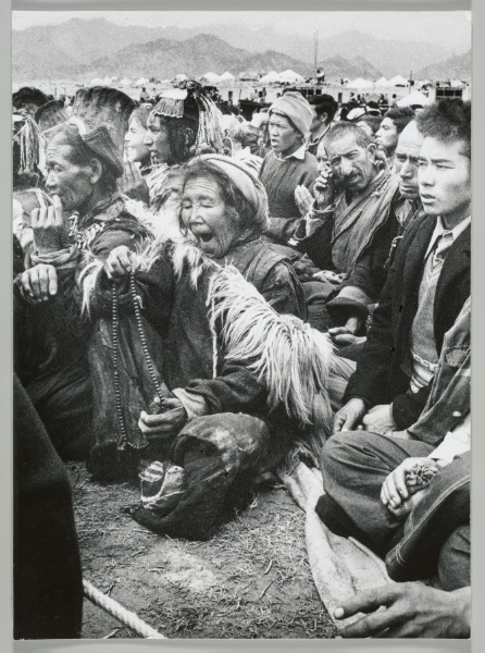 Seated woman with prayer beads, Sun Festival, Tibet