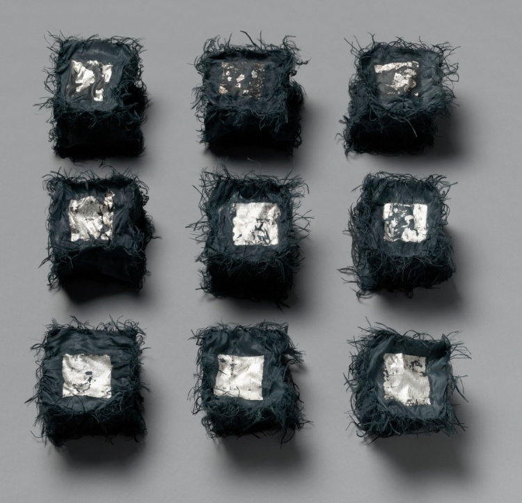 Nine Black Boxes with metal leaf