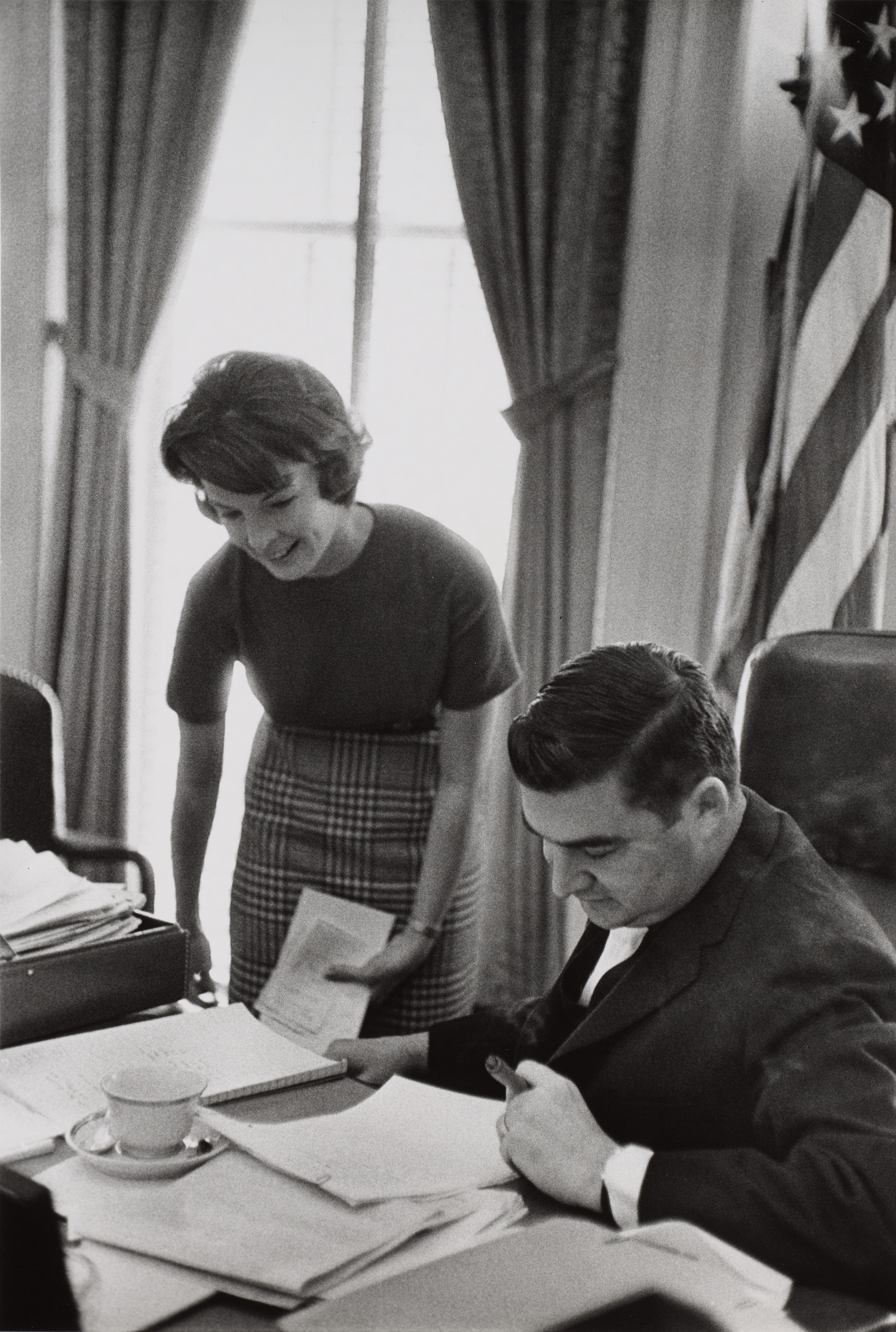 Press Secretary to the First Lady Pam Turnure and Press Secretary Pierre Salinger at a desk