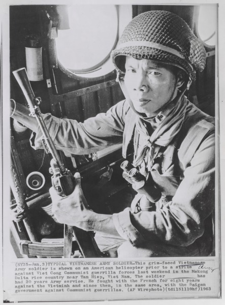 Typical Vietnamese Army Soldier: This grim-faced Vietnamese Army soldier is shown on an American helicopter prior to a strike against Viet Cong Communist guerrilla forces last weekend in the Mekong Delta rice country near Tan Hiep, Vietnam. The solider has had 20 years Army service. He fought with the French for eight years against the Vietminh and since then, in the same area, with the Saigon government against Communist guerrillas