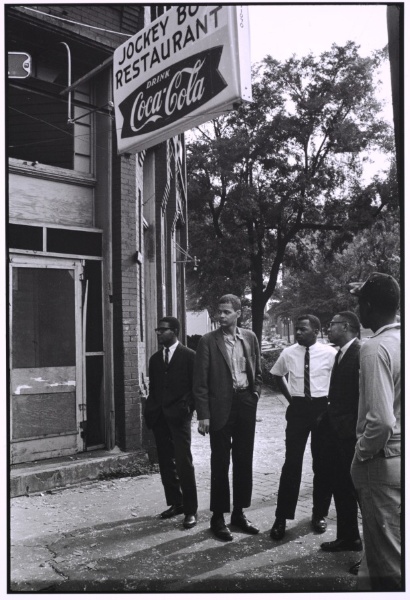 Jimmy Hicks, Julian Bond, John Lewis, and Jeremiah X stand across the street from the bombed church