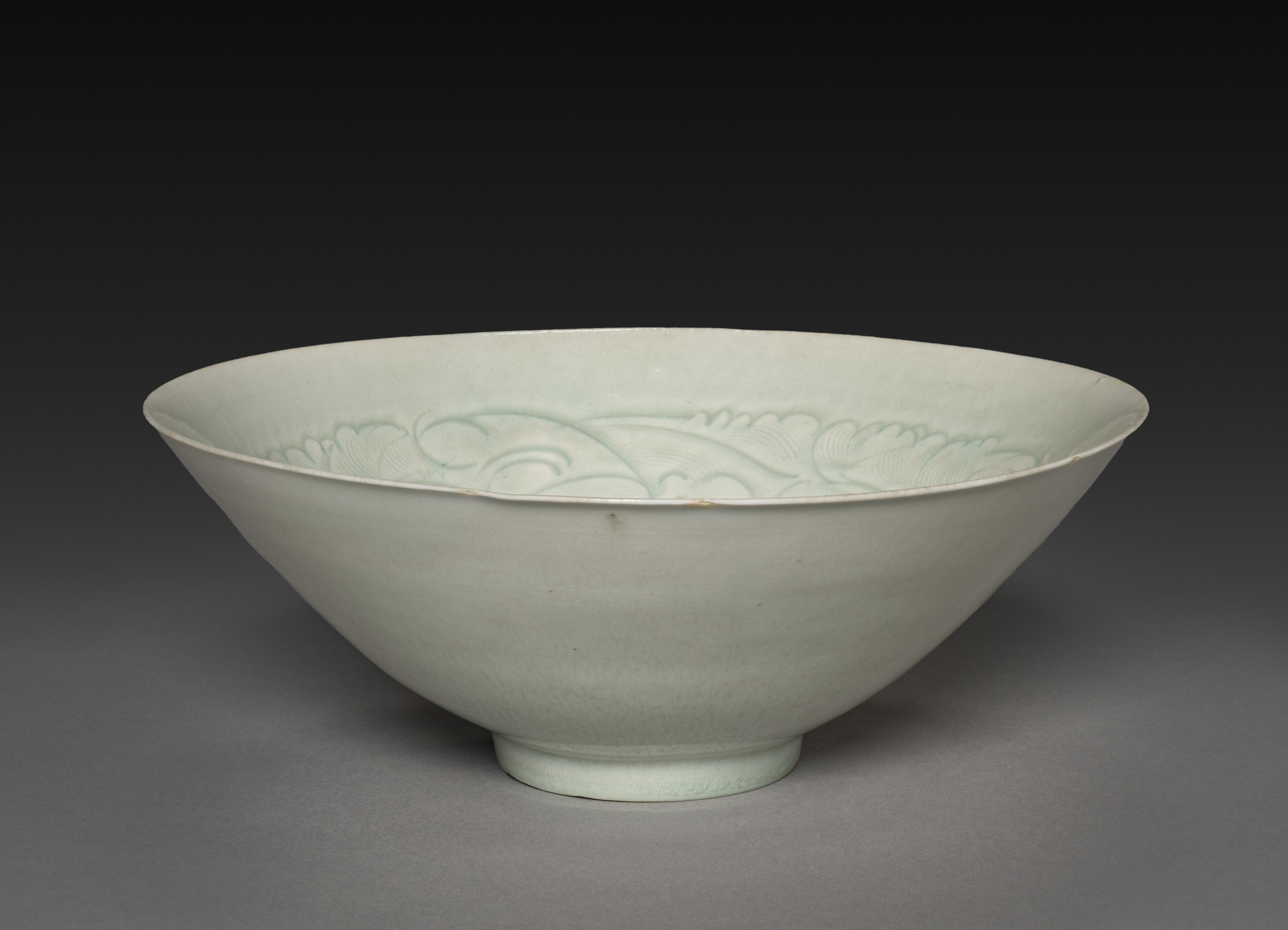 Conical Bowl with Carved Babies and Floral Motif