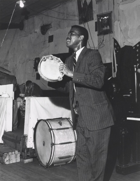 Store Front Churches: Man Playing Tambourine