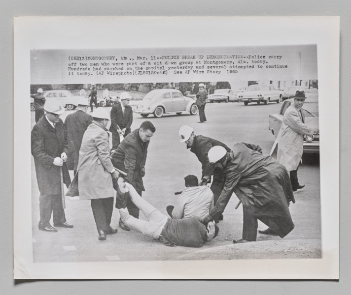 Police Break Up Demonstration: Police carry off two men who were part of a sit-down group at Montgomery, Alabama today. Hundreds had marched on the capitol yesterday and several attempted to continue it today. March 11, 1965