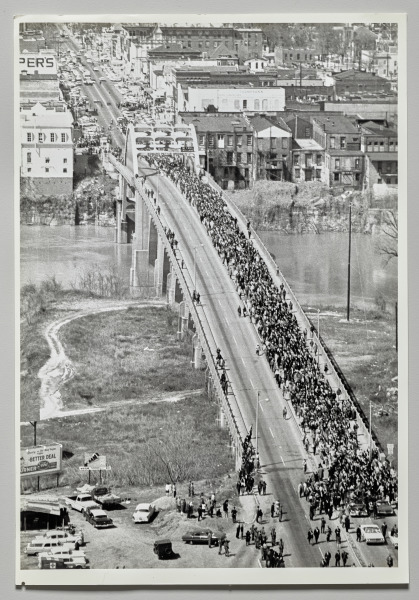 Over the Bridge on Rights March: Marchers stream across the Edmund Pettus Bridge over the Alabama River at Selma today on start of their five day, 50-mile march on the state capitol at Montgomery. The civil rights marchers, eight abreast, were led by Dr. Martin Luther King, March 21, 1965