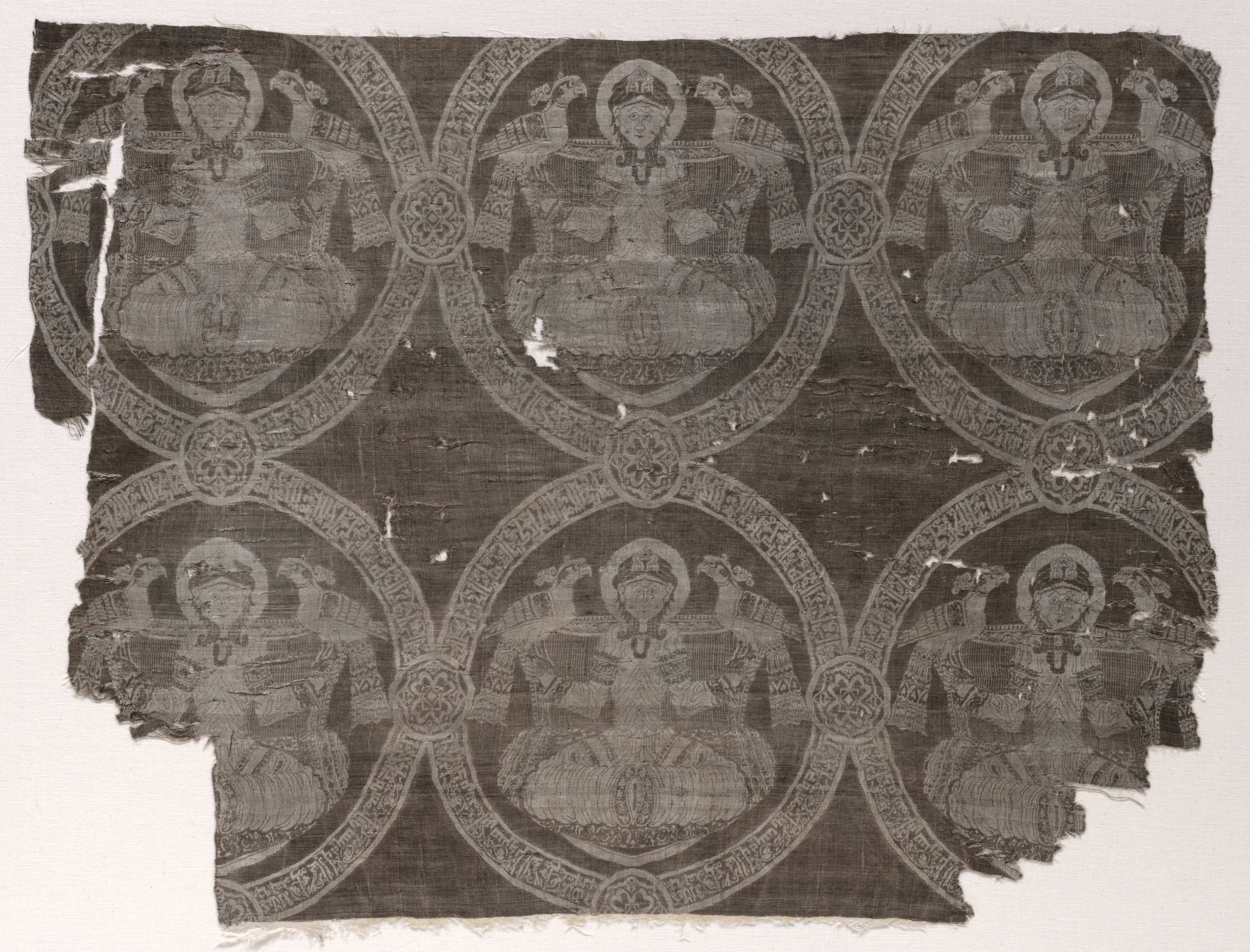 Fragment with seated prince holding falcons in kufic medallions