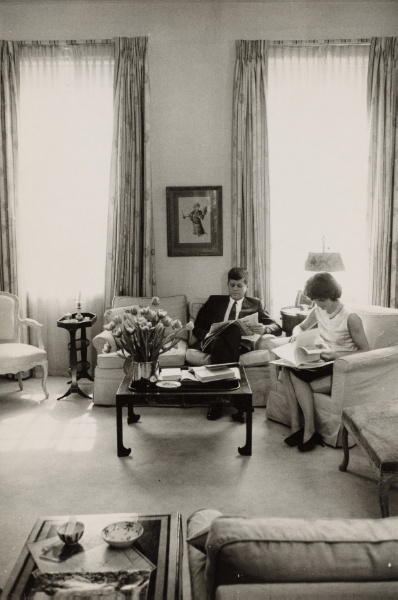 John F. Kennedy and Jackie Kennedy reading in sitting room