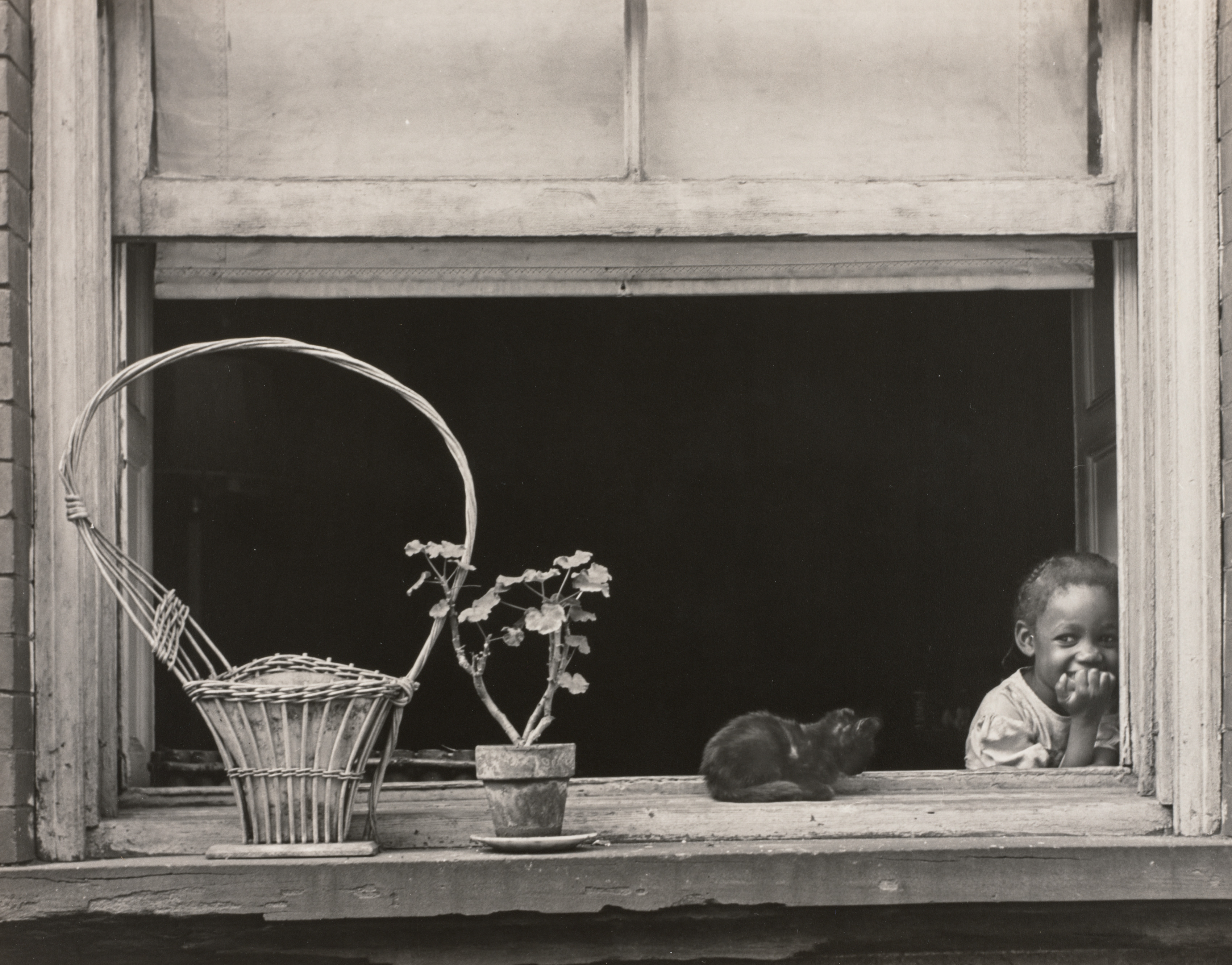 Little Girl in Window with Basket and Plant, East Harlem, New York