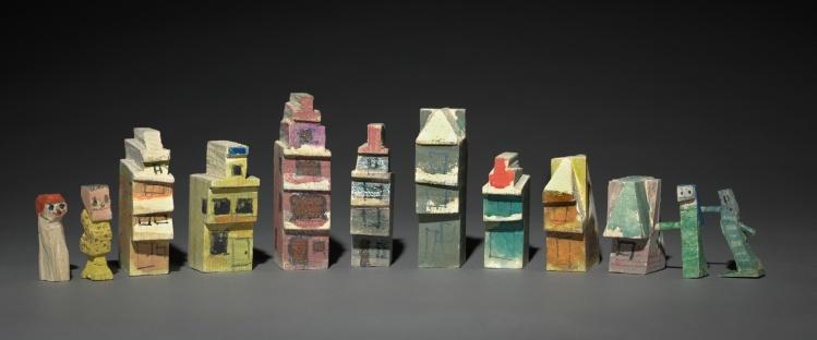 Group of Twelve Carved and Painted Objects: Eight Houses and Four Figures