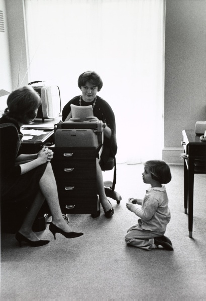 Young Caroline Kennedy playing by White House secretary Priscilla Wear's desk