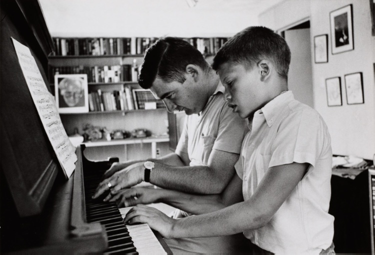 Press Secretary Pierre Salinger playing piano with son Marc