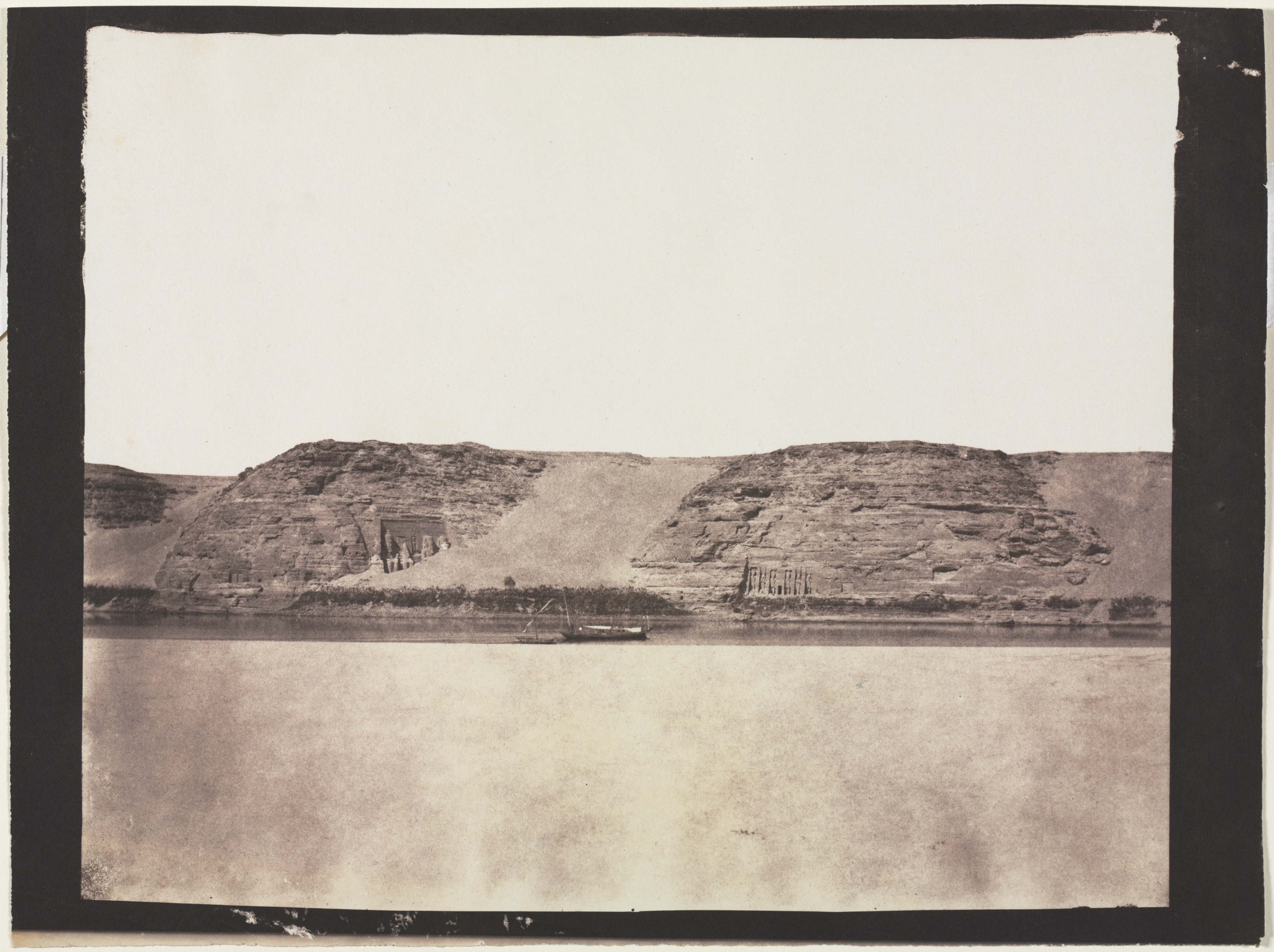 General View of Monuments Carved into Bedrock with Photographer's Dahabieh. Abu Simbel