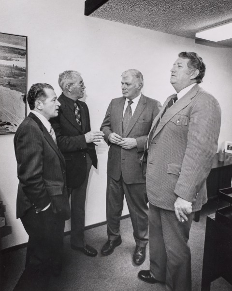 Four Men in Suits Chatting in Office, Tri-Valley Area, Northern California
