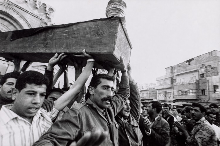 Men Carrying Wooden Box Through Crowd, Palestine